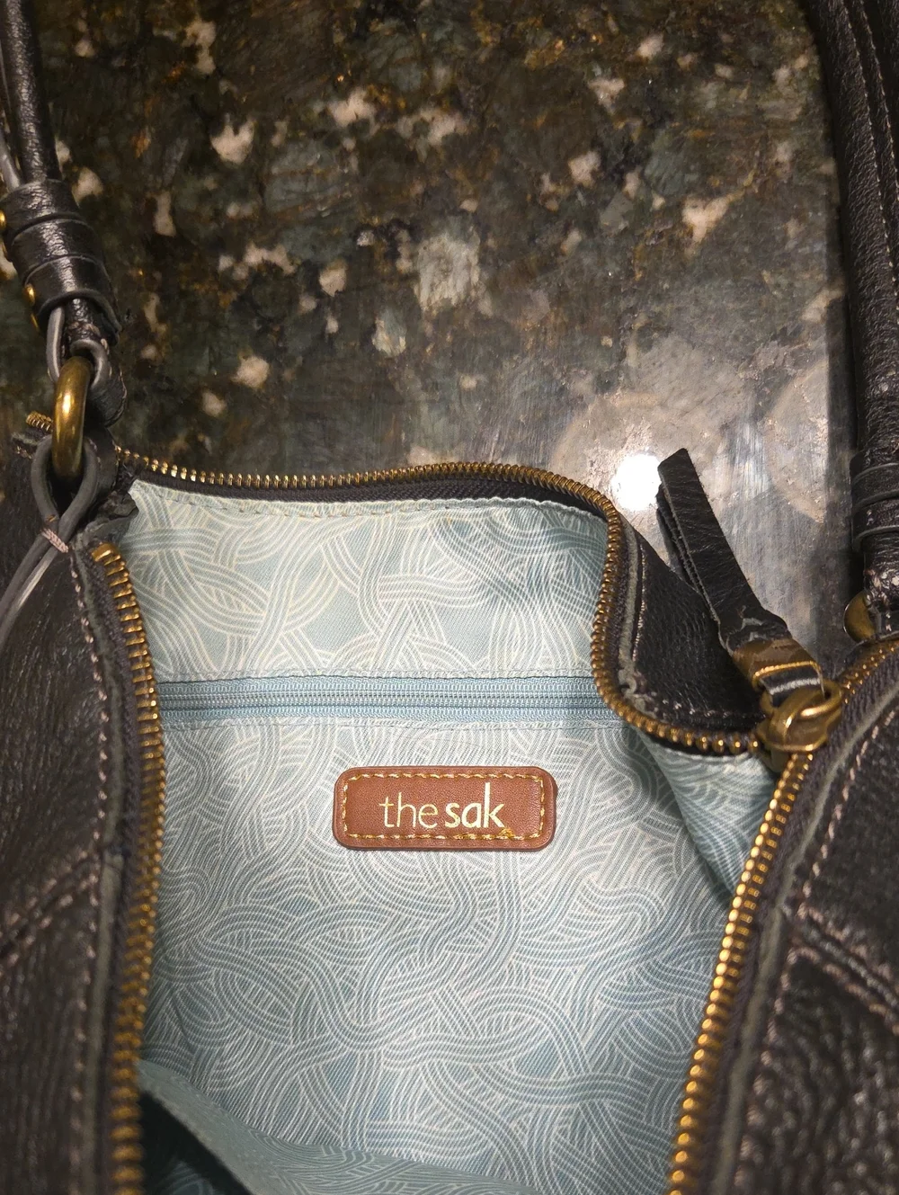 The Sak Black Pebbled Leather Shoulder Bag with Charm Accents